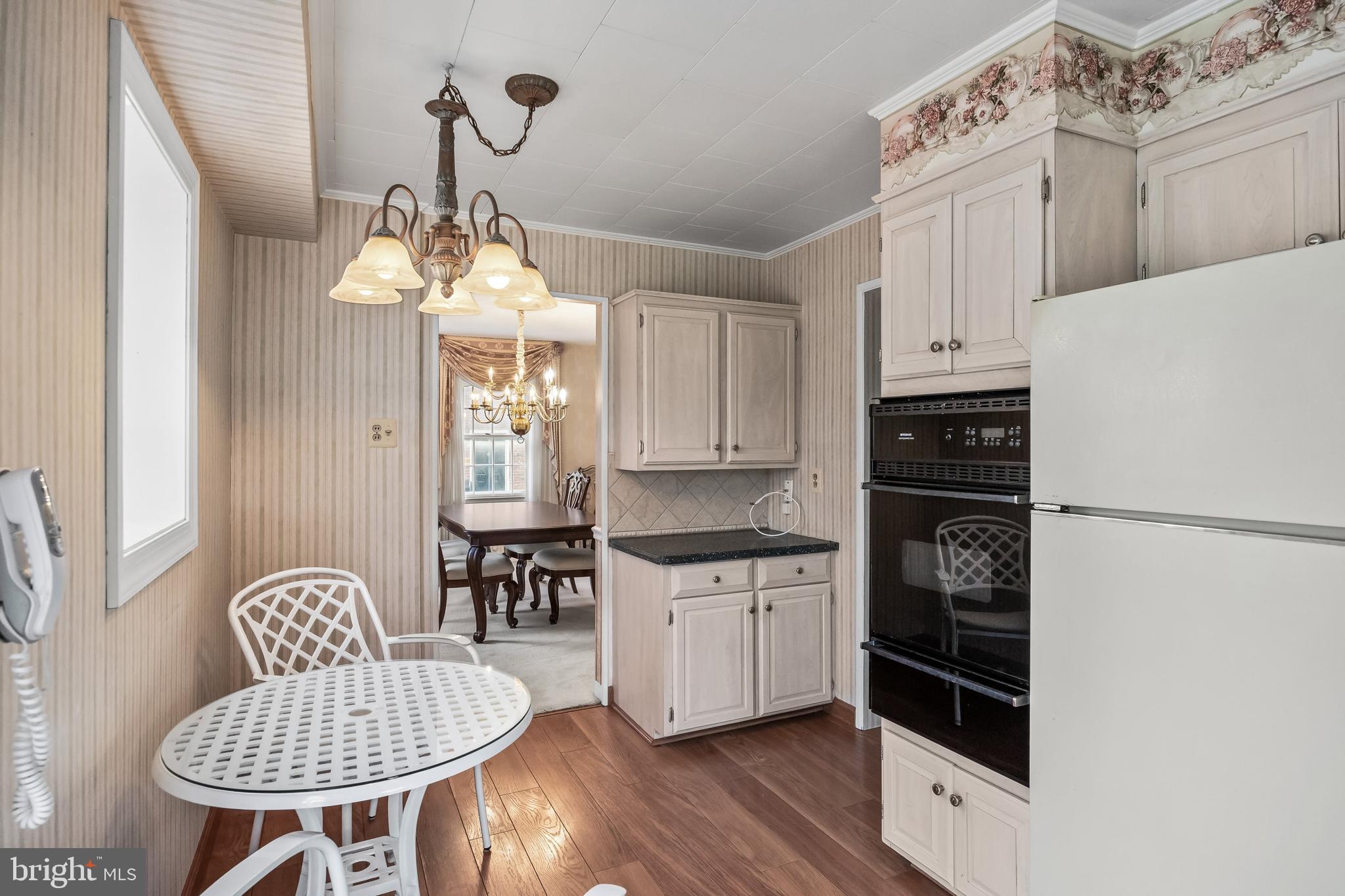 7 Colwick Road Cherry Hill, NJ 08002 - Photo 15 of 37 a kitchen with stainless steel appliances granite countertop a stove a refrigerator a dining table and chairs with wooden floor