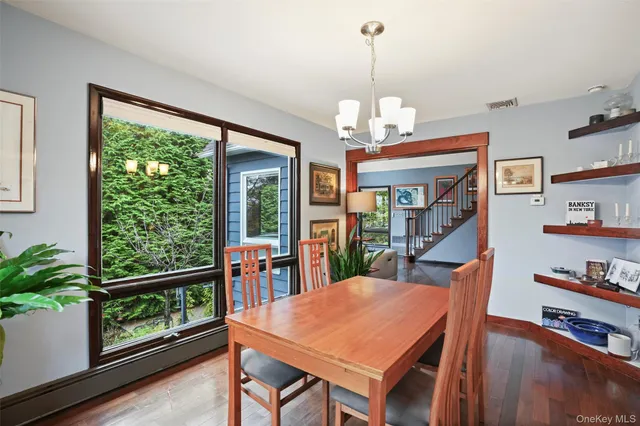 a view of a dining room with furniture window and wooden floor