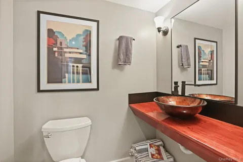 a bathroom with a toilet a sink and mirror