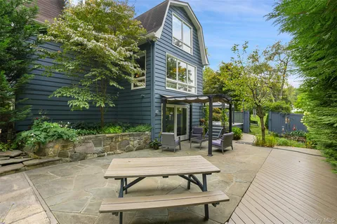 a view of a patio with table and chairs and potted plants