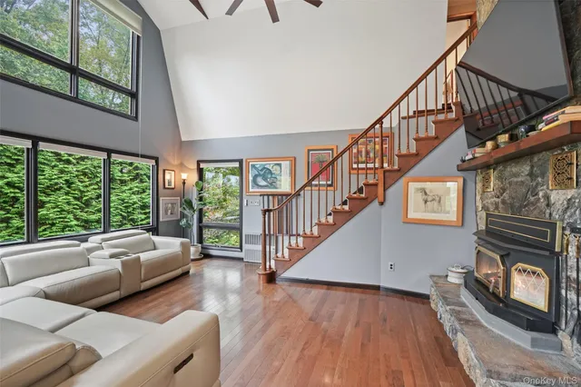 a living room with furniture a fireplace and a large window