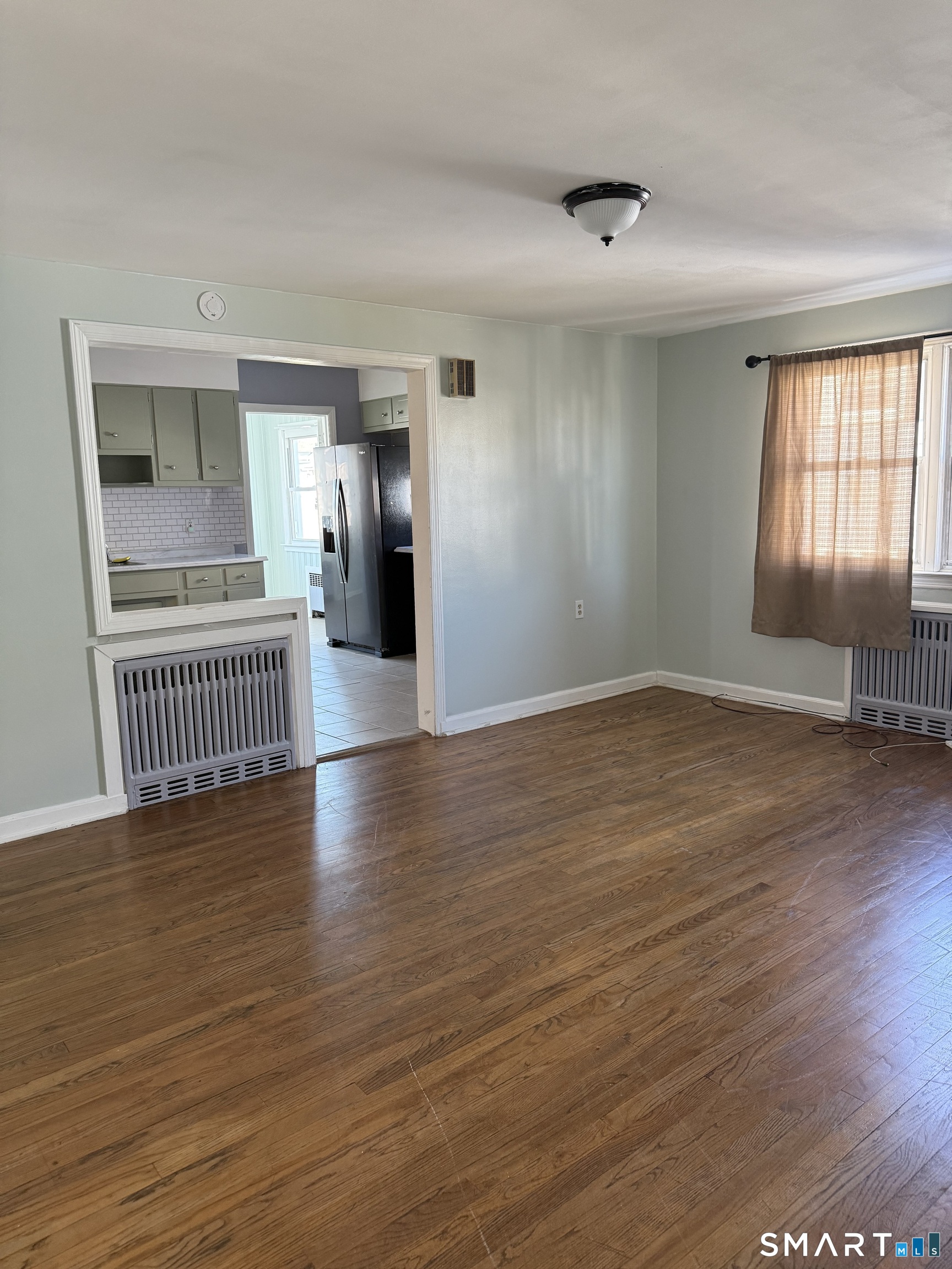 95-97 Locust Street Bridgeport, CT 06610 - Photo 14 of 16 a view of a room with wooden floor and a window