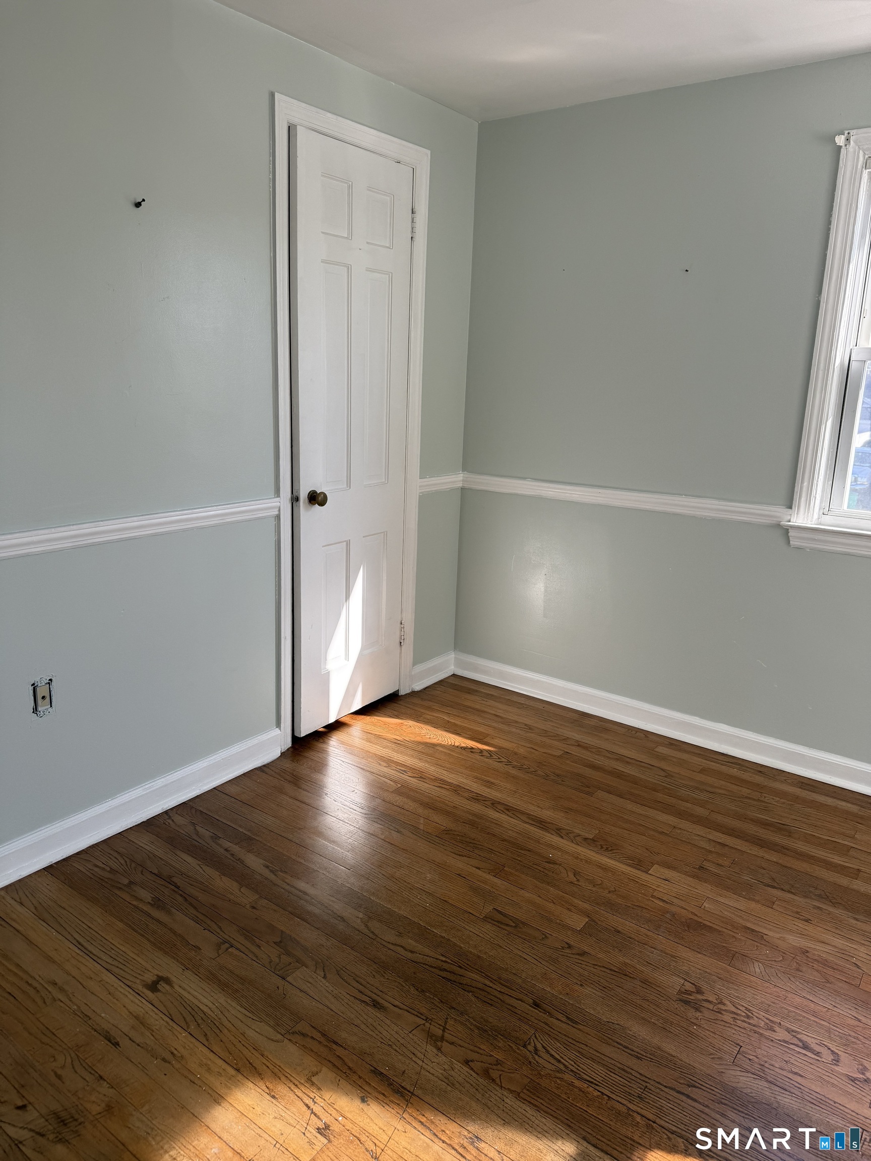 95-97 Locust Street Bridgeport, CT 06610 - Photo 16 of 16 a view of an empty room with wooden floor and a window