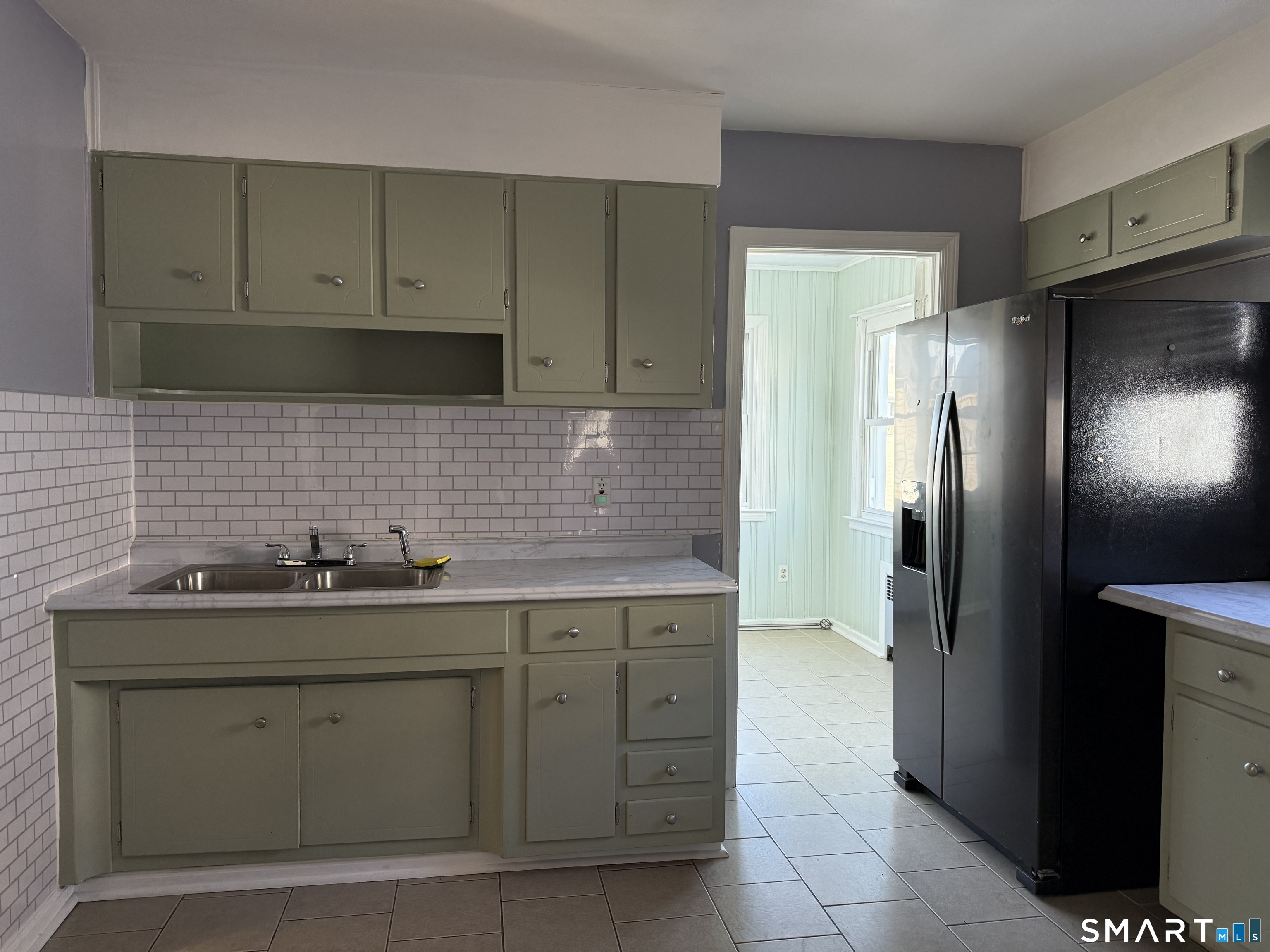 95-97 Locust Street Bridgeport, CT 06610 - Photo 9 of 16 a kitchen with stainless steel appliances granite countertop a sink stove and refrigerator