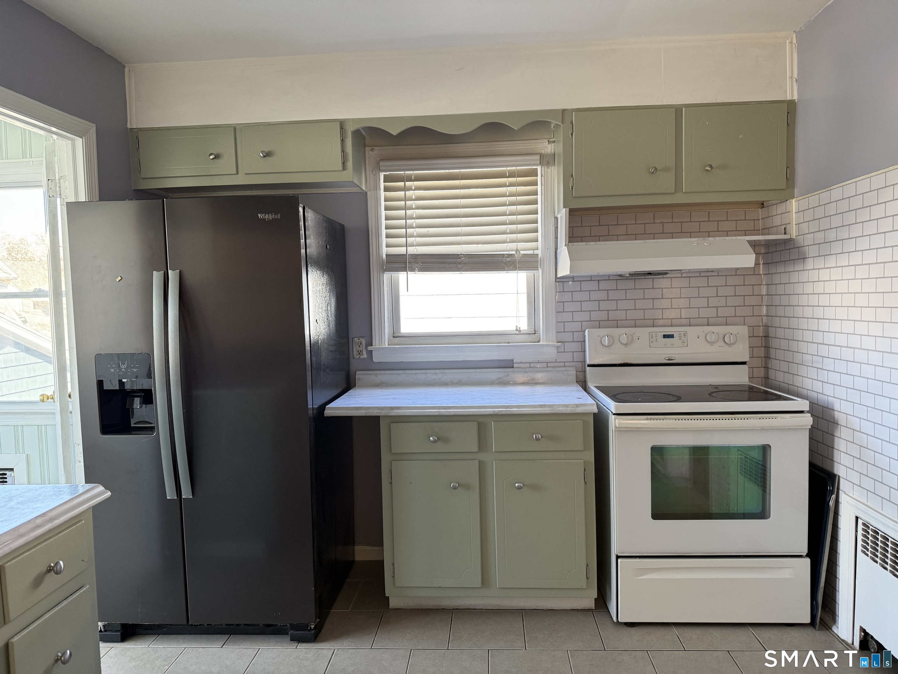95-97 Locust Street Bridgeport, CT 06610 - Photo 10 of 16 a kitchen with a stove and a refrigerator