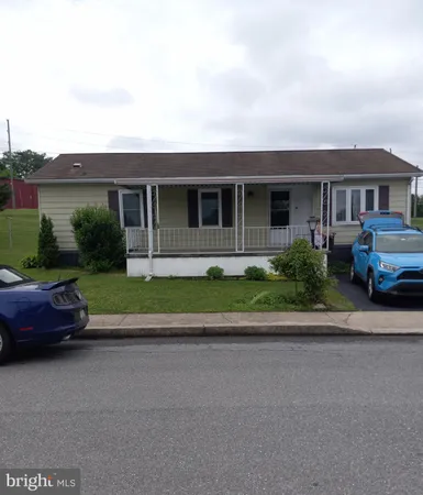 a front view of a house with a garden and plants