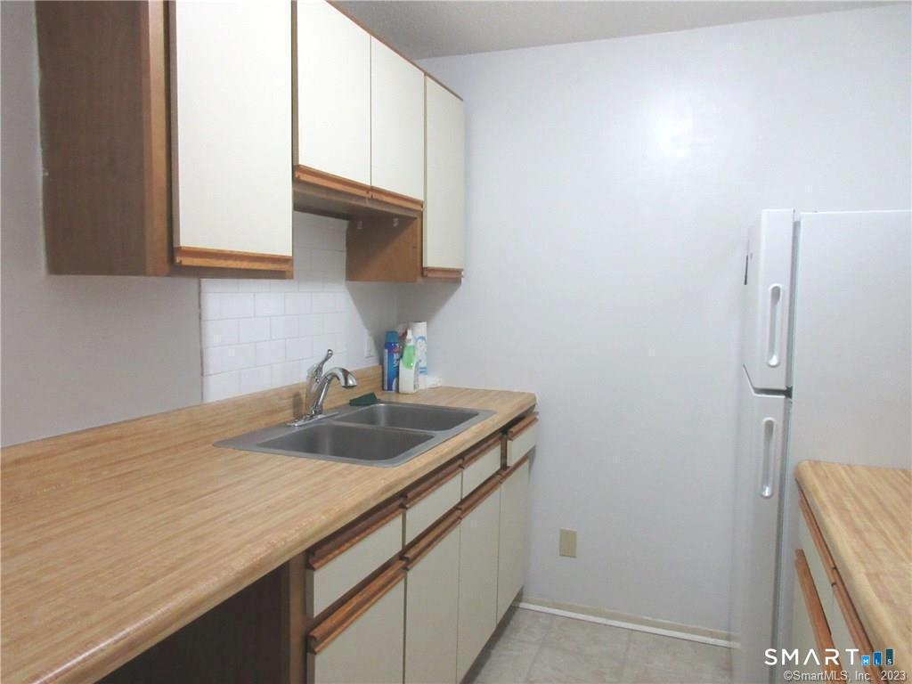 5 Nabby Road, Unit A17 Danbury, CT 06811 - Photo 6 of 11 a kitchen with a sink and cabinets
