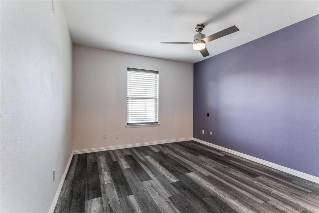 606 Ridgeline Drive Hurst, TX 76053 - Photo 11 of 29 wooden floor in an empty room with a window