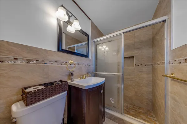 a bathroom with a sink a mirror and a shower