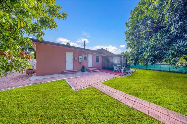 a view of a house with a yard porch and sitting area