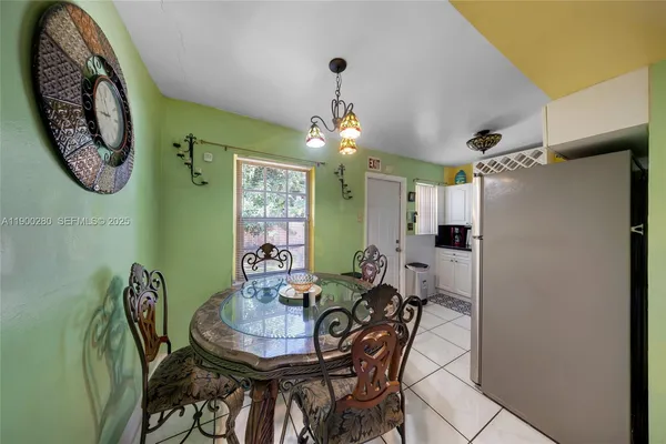a view of a dining room with furniture and a chandelier