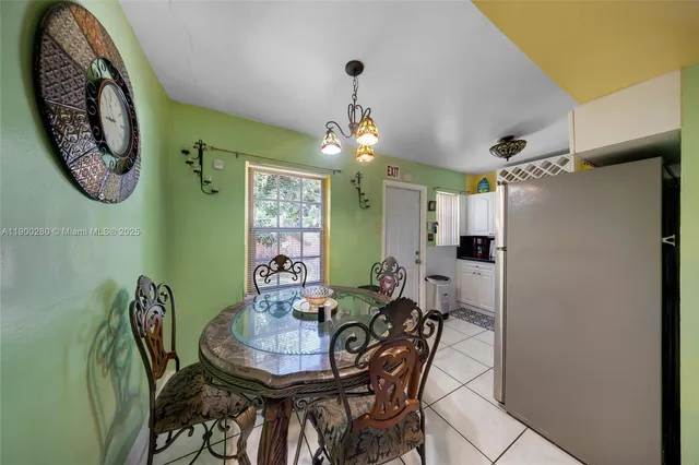 a view of a dining room with furniture and a chandelier