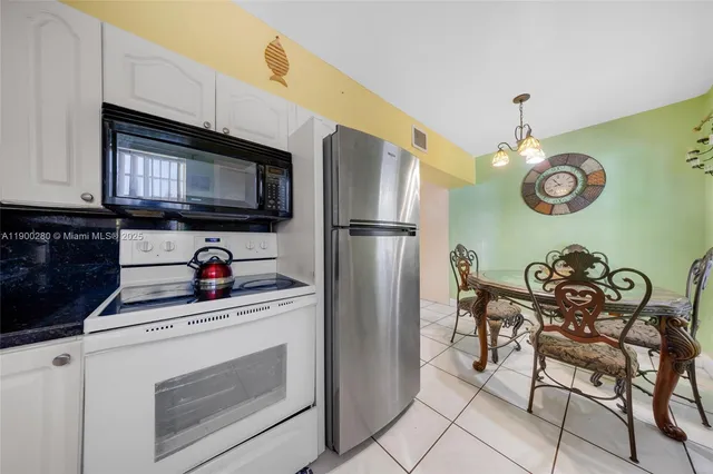 a kitchen with stainless steel appliances granite countertop a stove a microwave a sink and cabinets