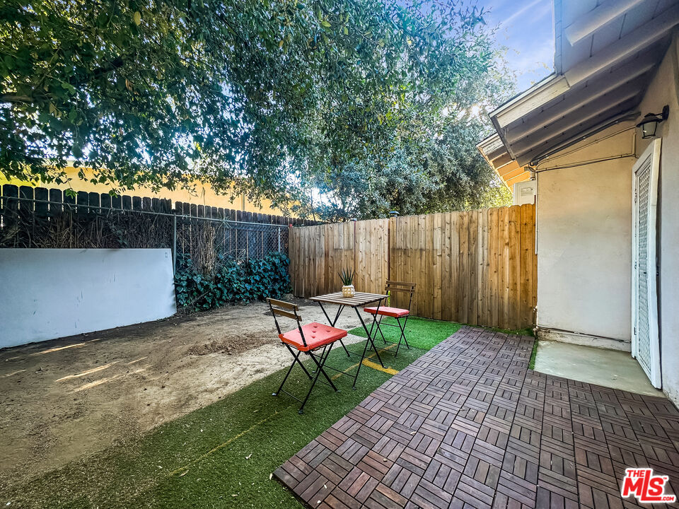 2944 Ronald Street Riverside, CA 92506 - Photo 21 of 37 a view of backyard with table and chairs and wooden fence