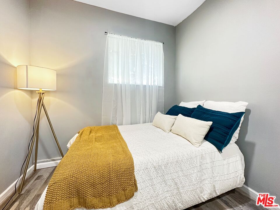 2944 Ronald Street Riverside, CA 92506 - Photo 24 of 37 a bedroom with a bed and wooden floor