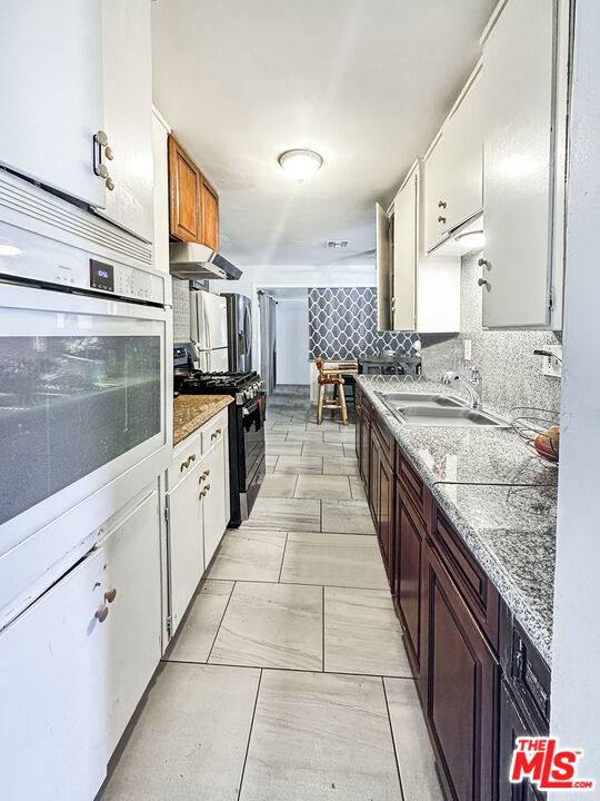 2944 Ronald Street Riverside, CA 92506 - Photo 10 of 37 a large kitchen with stainless steel appliances lots of counter space and a sink