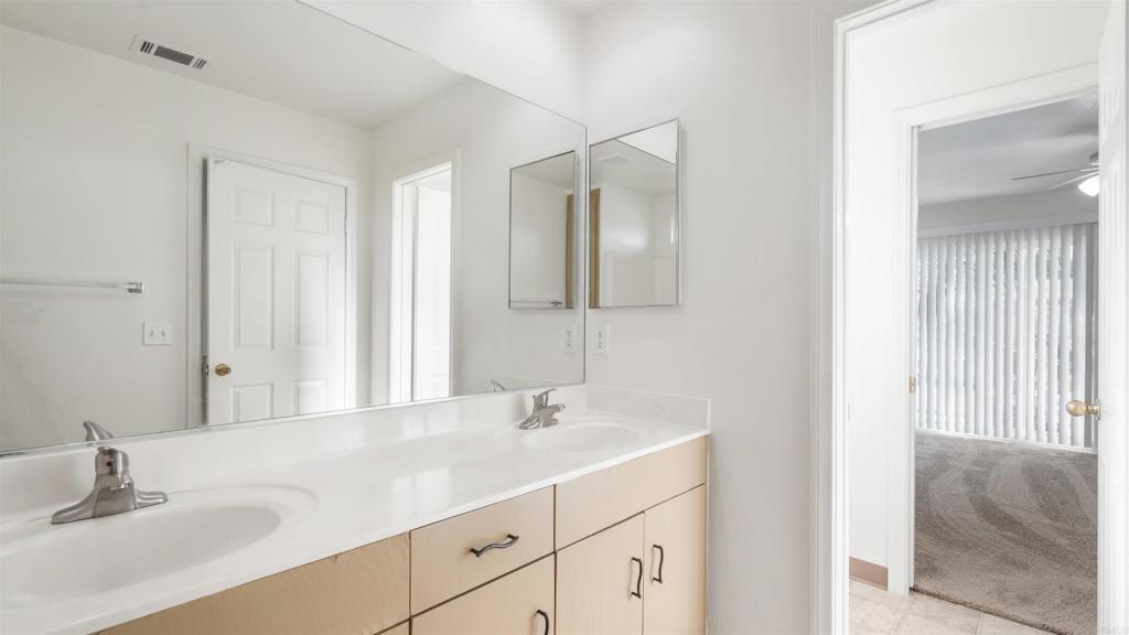 1428 Realty Road Ramona, CA 92065 - Photo 14 of 18 a bathroom with a sink and a mirror