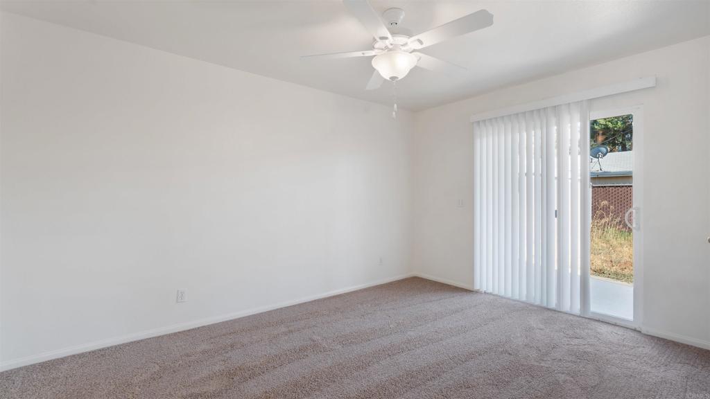 1428 Realty Road Ramona, CA 92065 - Photo 18 of 45 an empty room with windows and fan