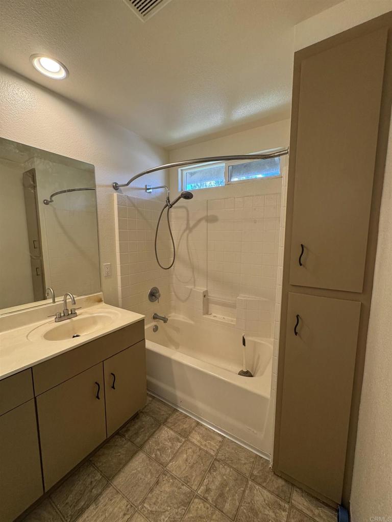 1428 Realty Road Ramona, CA 92065 - Photo 31 of 45 a spacious bathroom with a granite countertop sink a mirror and a bathtub