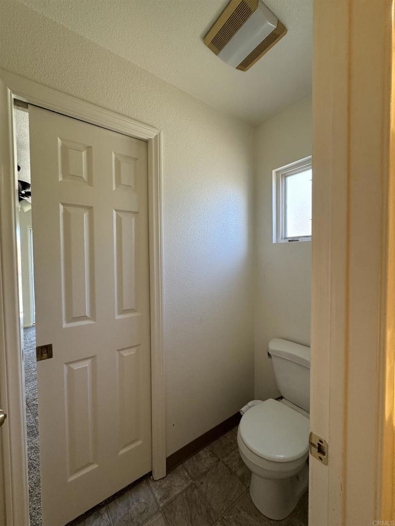 1428 Realty Road Ramona, CA 92065 - Photo 32 of 45 a white toilet sitting next to a bathroom sink