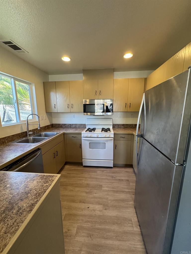 1428 Realty Road Ramona, CA 92065 - Photo 35 of 45 a kitchen with a sink a stove a refrigerator and a sink