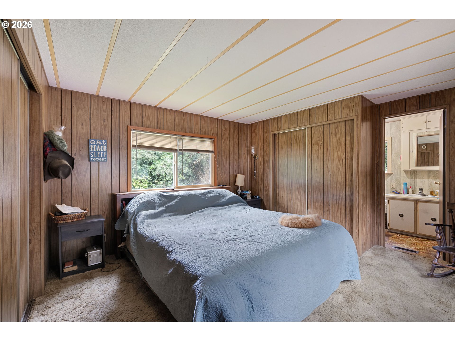 4826 Rhododendron Loop Florence, OR 97439 - Photo 25 of 41 a bedroom with a bed a table and chair