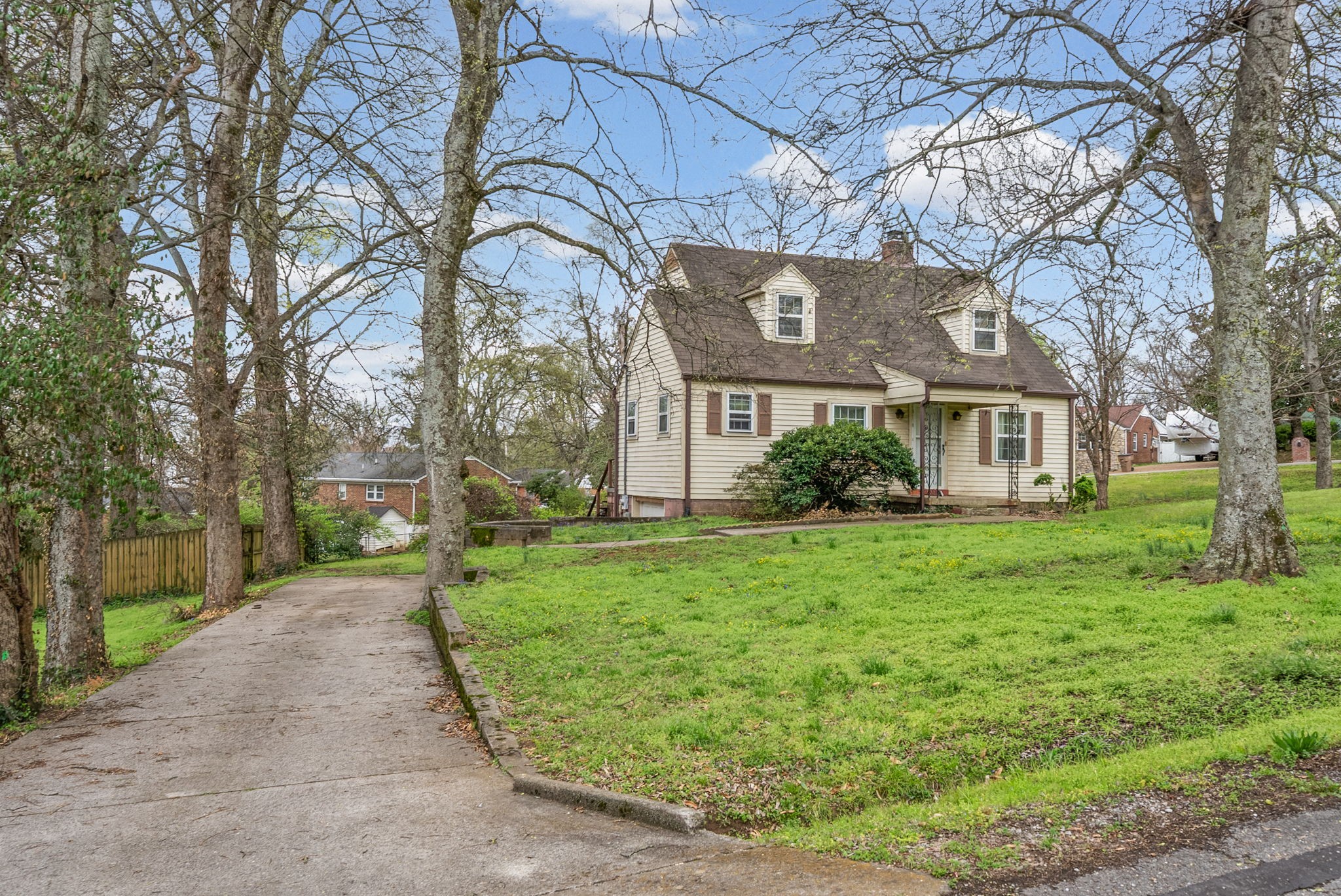 210 Cliffdale Road Nashville, TN 37214 - Photo 2 of 38 a view of a brick house with a big yard plants and large trees