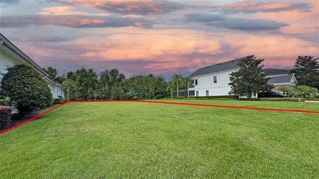a view of green field with house in the background