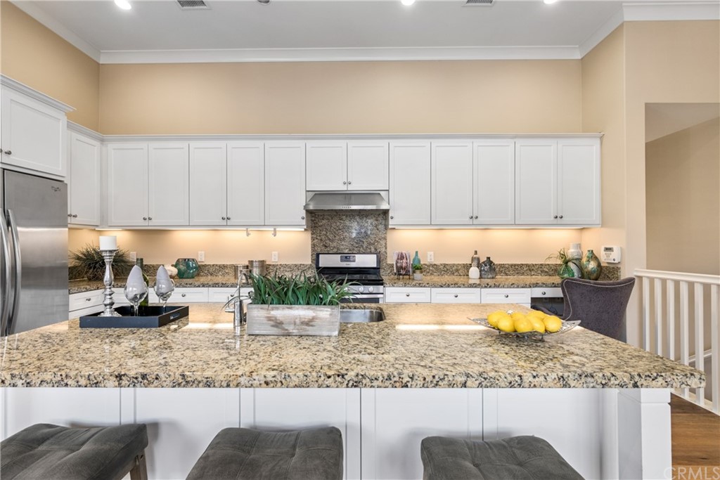 97 Mayfair Irvine, CA 92620 - Photo 11 of 42 a kitchen with a refrigerator a stove a sink and dishwasher