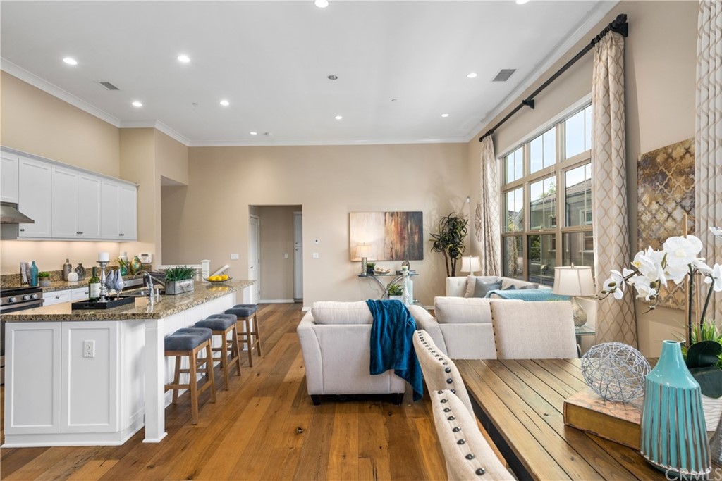 97 Mayfair Irvine, CA 92620 - Photo 16 of 42 a living room with furniture a wooden floor and a large window