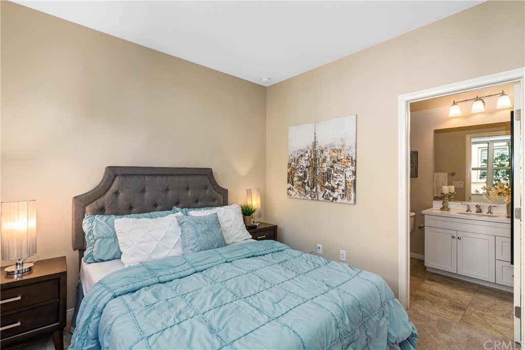 97 Mayfair Irvine, CA 92620 - Photo 19 of 42 a bedroom with a large bed and a chandelier