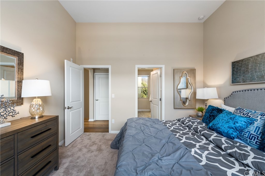 97 Mayfair Irvine, CA 92620 - Photo 24 of 42 a bedroom with a bed and a lamp on dresser