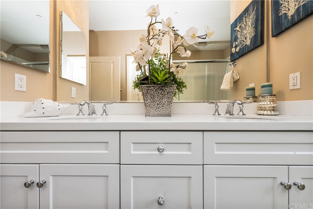 97 Mayfair Irvine, CA 92620 - Photo 26 of 42 a bathroom with a sink and a mirror