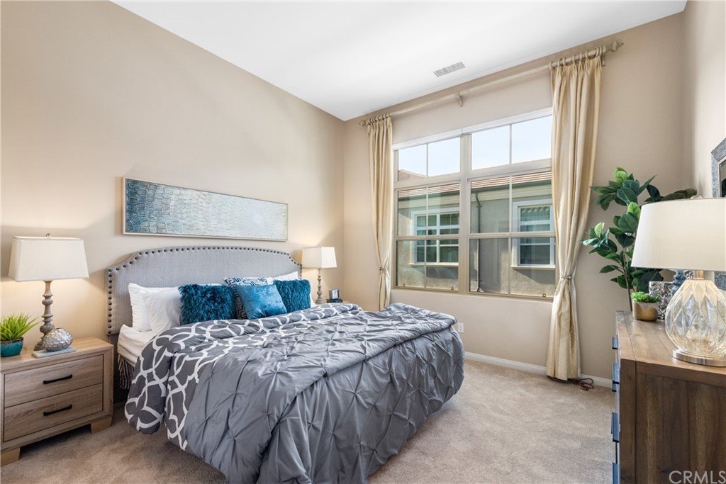 97 Mayfair Irvine, CA 92620 - Photo 4 of 42 a bedroom with a bed and a lamp on table