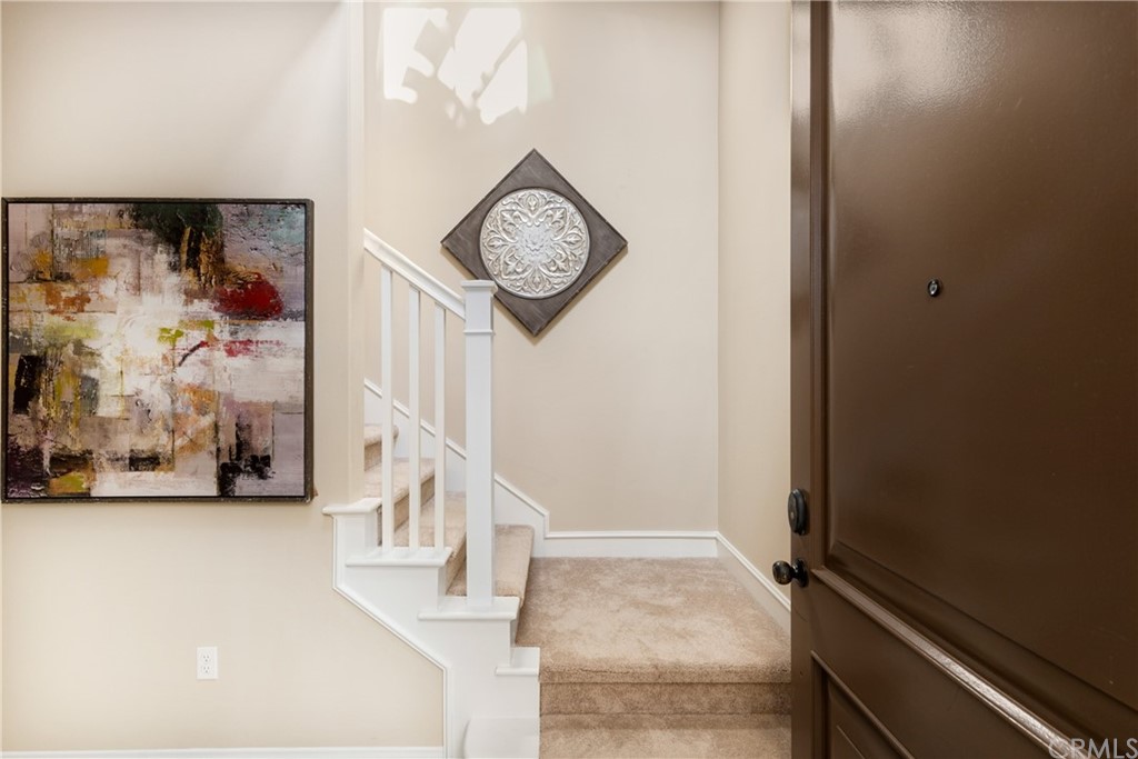 97 Mayfair Irvine, CA 92620 - Photo 6 of 42 a view of a hallway with paintings on the wall