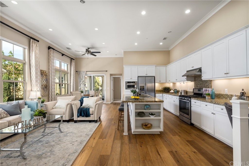 97 Mayfair Irvine, CA 92620 - Photo 8 of 42 a large kitchen with stainless steel appliances and wooden floors