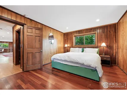 a bedroom with a bed and a large window