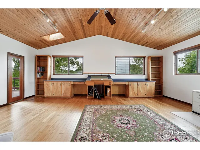 a bedroom with a bed and a book shelf