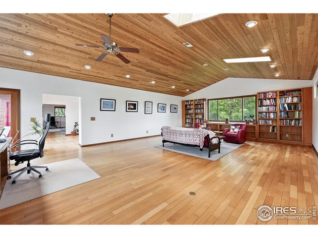 a living room with furniture and a book shelf