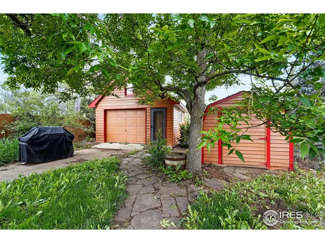 a picture of a house with a yard and potted plants