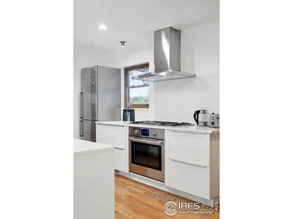 a kitchen with stainless steel appliances a stove and more cabinets