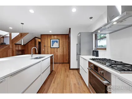 a kitchen that has a sink and a stove