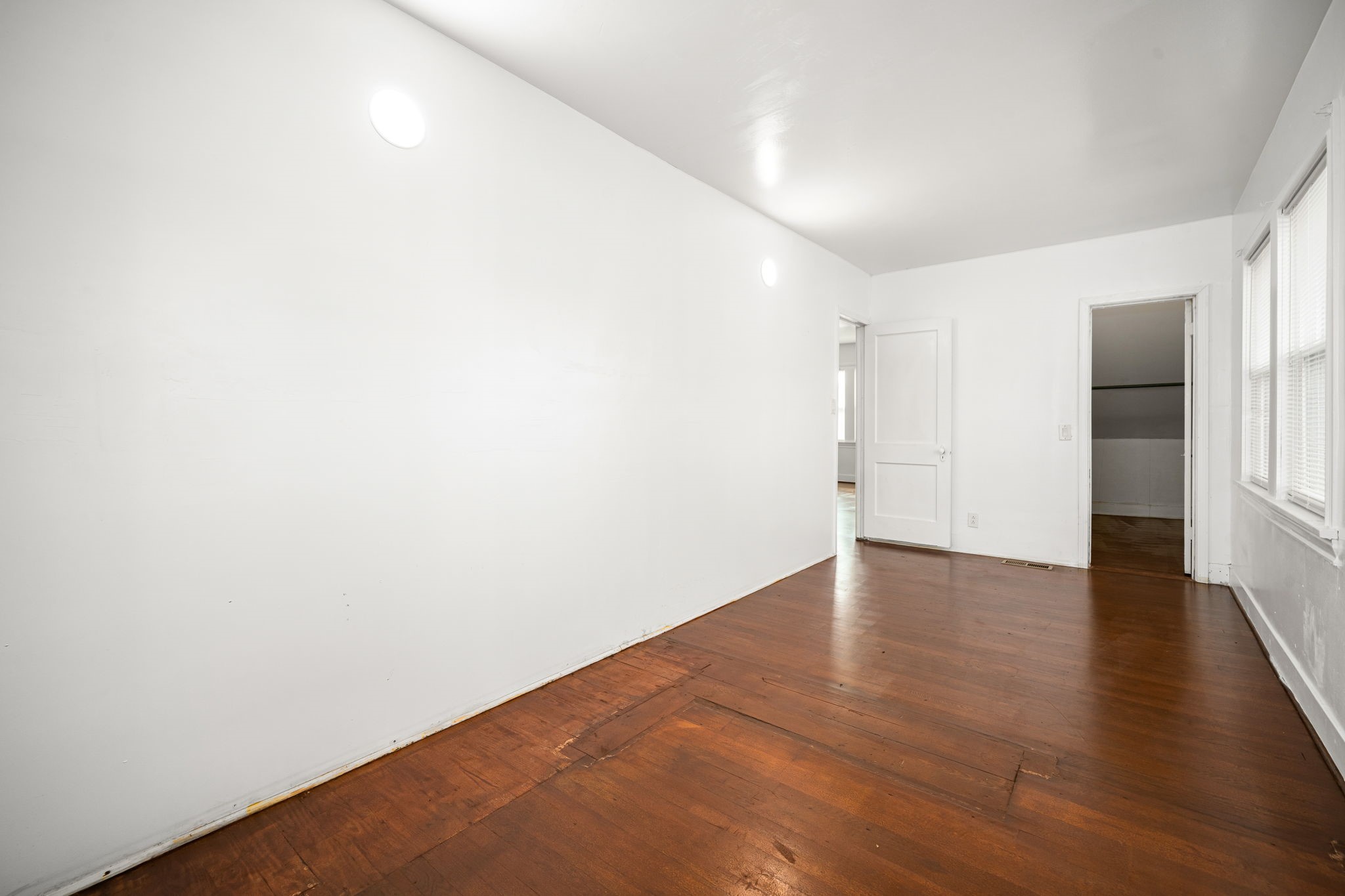 1202 Barkdull Street Houston, TX 77006 - Photo 18 of 48 an empty room with wooden floor and windows