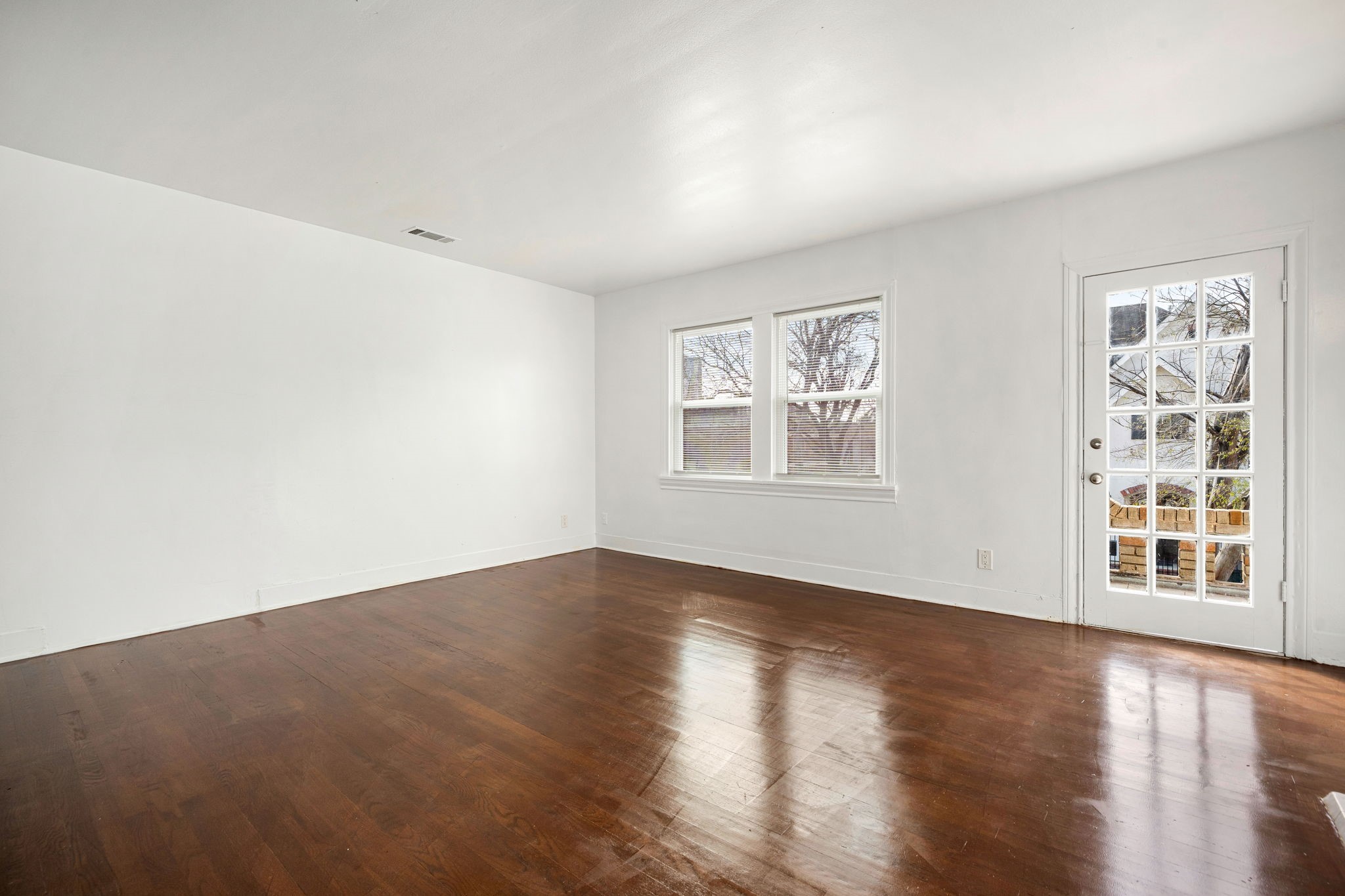 1202 Barkdull Street Houston, TX 77006 - Photo 25 of 48 a view of an empty room with a window and wooden floor