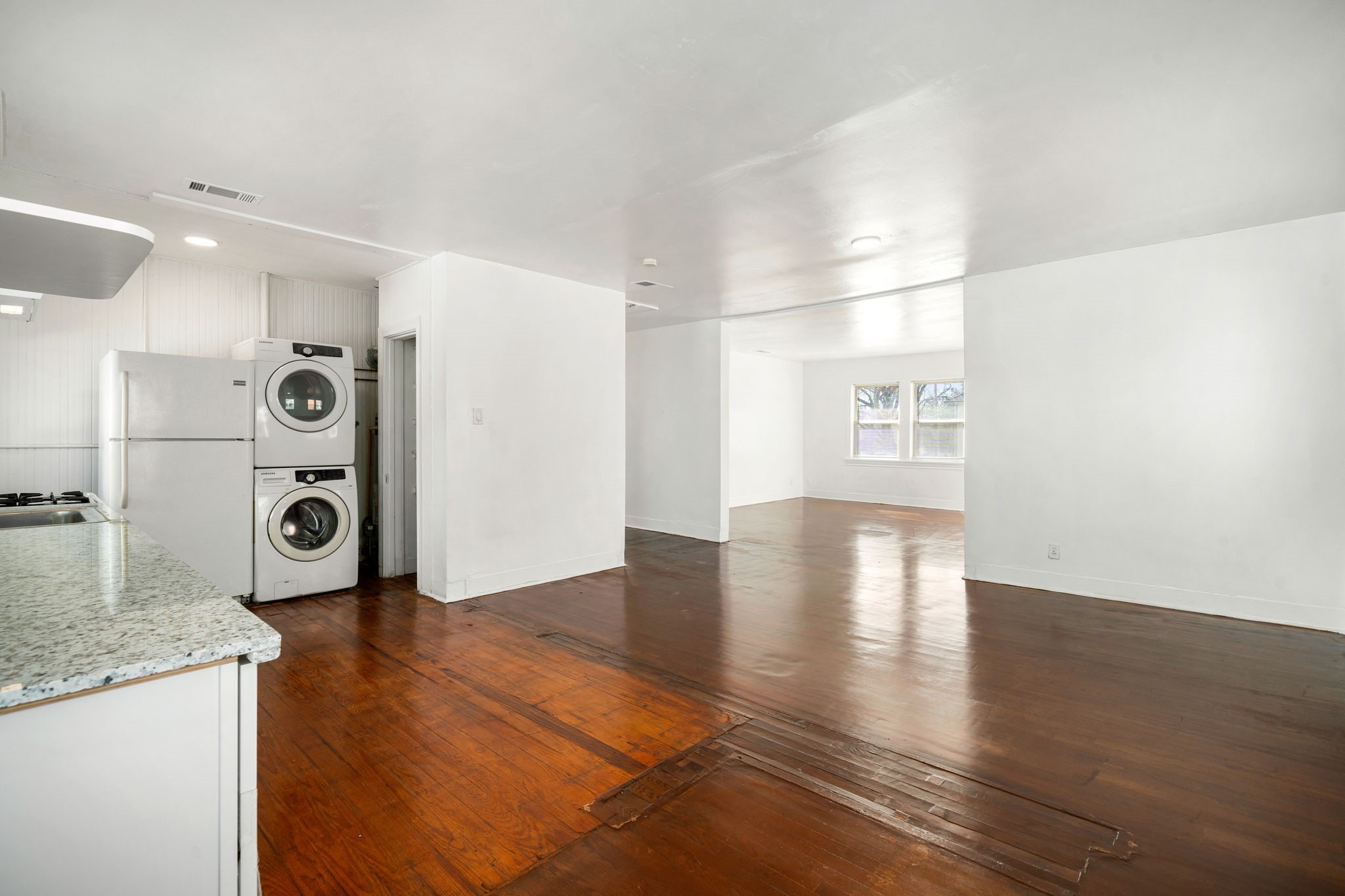 1202 Barkdull Street Houston, TX 77006 - Photo 26 of 48 a view of a refrigerator in kitchen and wooden floor
