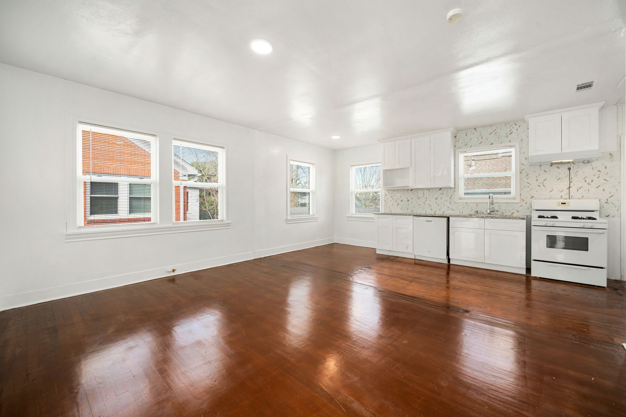 1202 Barkdull Street Houston, TX 77006 - Photo 29 of 48 a view of a kitchen with wooden floor and electronic appliances