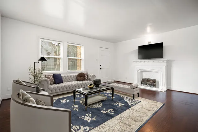 a living room with furniture a fireplace and a flat screen tv