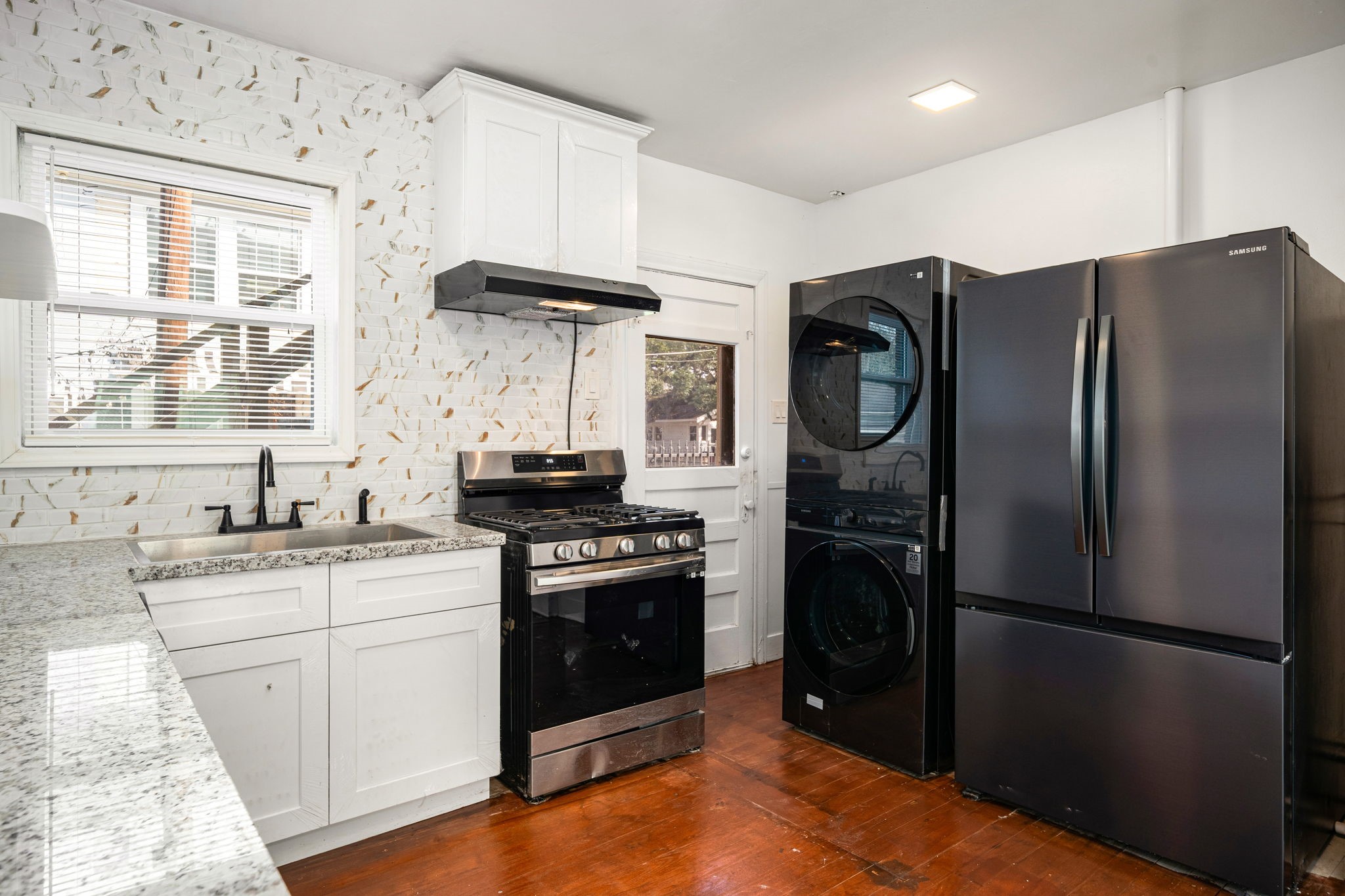 1202 Barkdull Street Houston, TX 77006 - Photo 9 of 48 a kitchen with stainless steel appliances granite countertop a refrigerator a sink and a stove