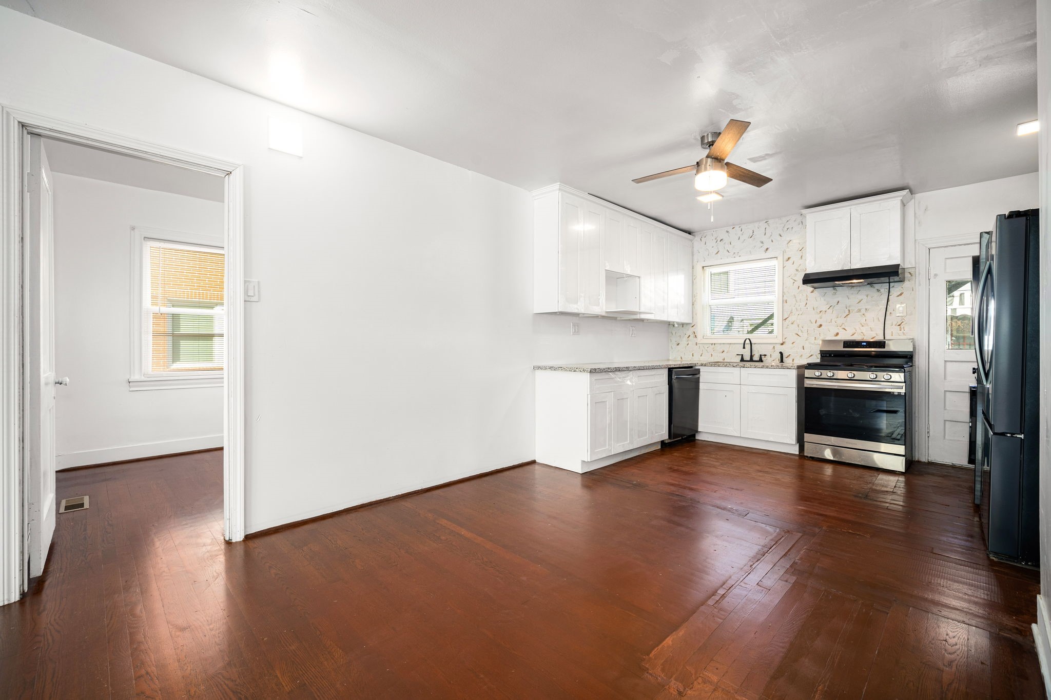 1202 Barkdull Street Houston, TX 77006 - Photo 10 of 48 a view of kitchen with wooden floor electronic appliances and window