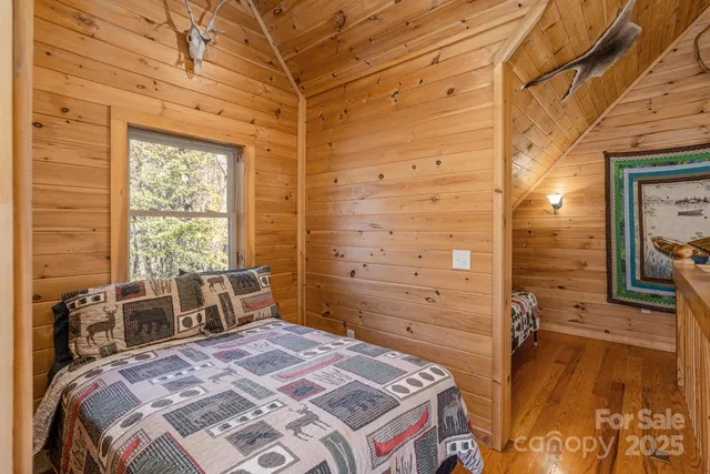 a bedroom with a bed next to a window with the outer view